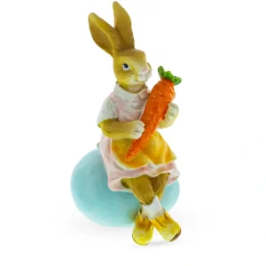 Springtime Serenity: Mother Bunny Cradling Carrot Atop A Decorative Easter Egg Figurine - CaringForTots - Professional Baby and Children's Products | Caring for Growth, Caring for Every Moment* Bunnies